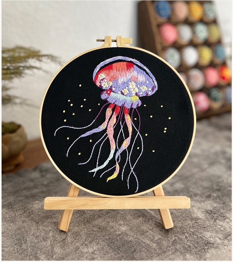 Finished jellyfish embroidery in an 8 inch hoop on an easel